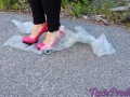 Pink high heels pop bags outdoors