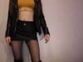 Skinny girl in boots and leather shorts moves sexually