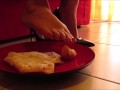 High heels and barefoot crush of a cream cake