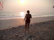 Nice lady at lonely nudist beach. Red swimsuit. Red bikini. Coconut