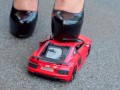 Crush of Red Audi R8 model toy car with Black Pump Stilettos