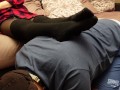 A slave in a collar is kneeling legs in black socks and tights