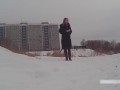 Winter street photoshoot in a fur coat on a naked body