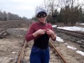 Girl undresses on the train tracks