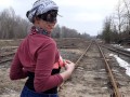 Girl undresses on the train tracks