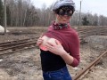 Girl undresses on the train tracks