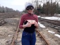 Girl undresses on the train tracks