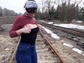 Girl undresses on the train tracks