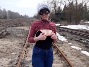 Girl undresses on the train tracks