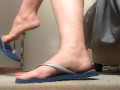 dangling and showing off sexy feet in flipflops
