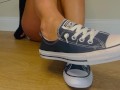 Sexy feet coming out of Chuck Taylor Converse chucks shoe tease