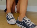 Sexy feet coming out of Chuck Taylor Converse chucks shoe tease
