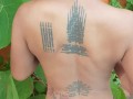 Slave May is showing her tattoos next to the swimming pool