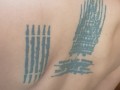 Slave May is showing her tattoos next to the swimming pool