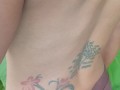 Slave May is showing her tattoos next to the swimming pool
