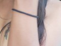 Slave May is showing her tattoos next to the swimming pool
