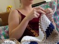 Creature crocheting and singing a tune