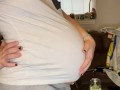 Pregnant milf strips and massages herself with lotion