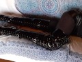 Laura on Heels amateur 2021 on a sofa wearing black sexy platform boots over the knees