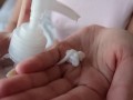 pretty woman with a toned body lubricates her legs with cream