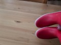 Cumming on her red rubberboots