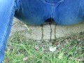 Pissing jeans in public street in sunny day