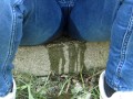 Pissing jeans in public street in sunny day