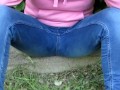 Pissing jeans in public street in sunny day