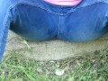 Pissing jeans in public street in sunny day