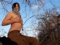Girl undresses in nature