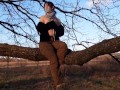 Girl undresses in nature