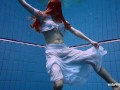 Redhead Marketa in a white dress in the pool