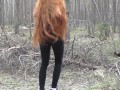 Redhead girl with long hair walking in the park