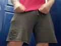 Muscle legs pose and piss at gym