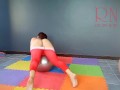 A girl without panties is engaged in yoga. The athlete takes off yoga leotards and shows her pussy.