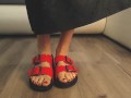 Girl in sexy red flip flops back from the beach