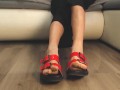 Girl in sexy red flip flops back from the beach