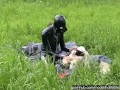 Rubber girl full in black latex catsuit and mask plays with herself outdoor in a meadow - Part 1