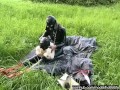 Rubber girl full in black latex catsuit and mask plays with herself outdoor in a meadow - Part 1