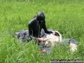 Rubber girl full in black latex catsuit and mask plays with herself outdoor in a meadow - Part 1