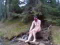 Walking naked in the forest by a mountain river