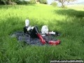 Rubber Girl Full in Black Latex Catsuit and Mask Plays with herself Outdoor in a Meadow - Part 3