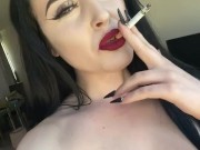 Casually smoking a cork cigarette with dark lipstick on