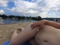 Girl caresses herself on a nude beach