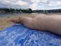 Girl caresses herself on a nude beach