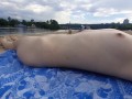 Girl caresses herself on a nude beach