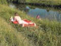 Riverside naked milf sunbathing is not shy about random fisher. Outdoors. Wild beach. Public nudity