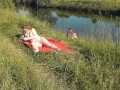 Riverside naked milf sunbathing is not shy about random fisher. Outdoors. Wild beach. Public nudity