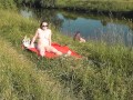 Riverside naked milf sunbathing is not shy about random fisher. Outdoors. Wild beach. Public nudity