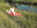 Riverside naked milf sunbathing is not shy about random fisher. Outdoors. Wild beach. Public nudity